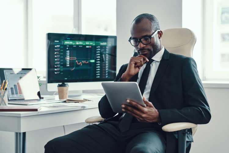 A business intelligence analyst works on a tablet.