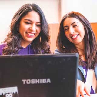 Two UW students working together on the computer