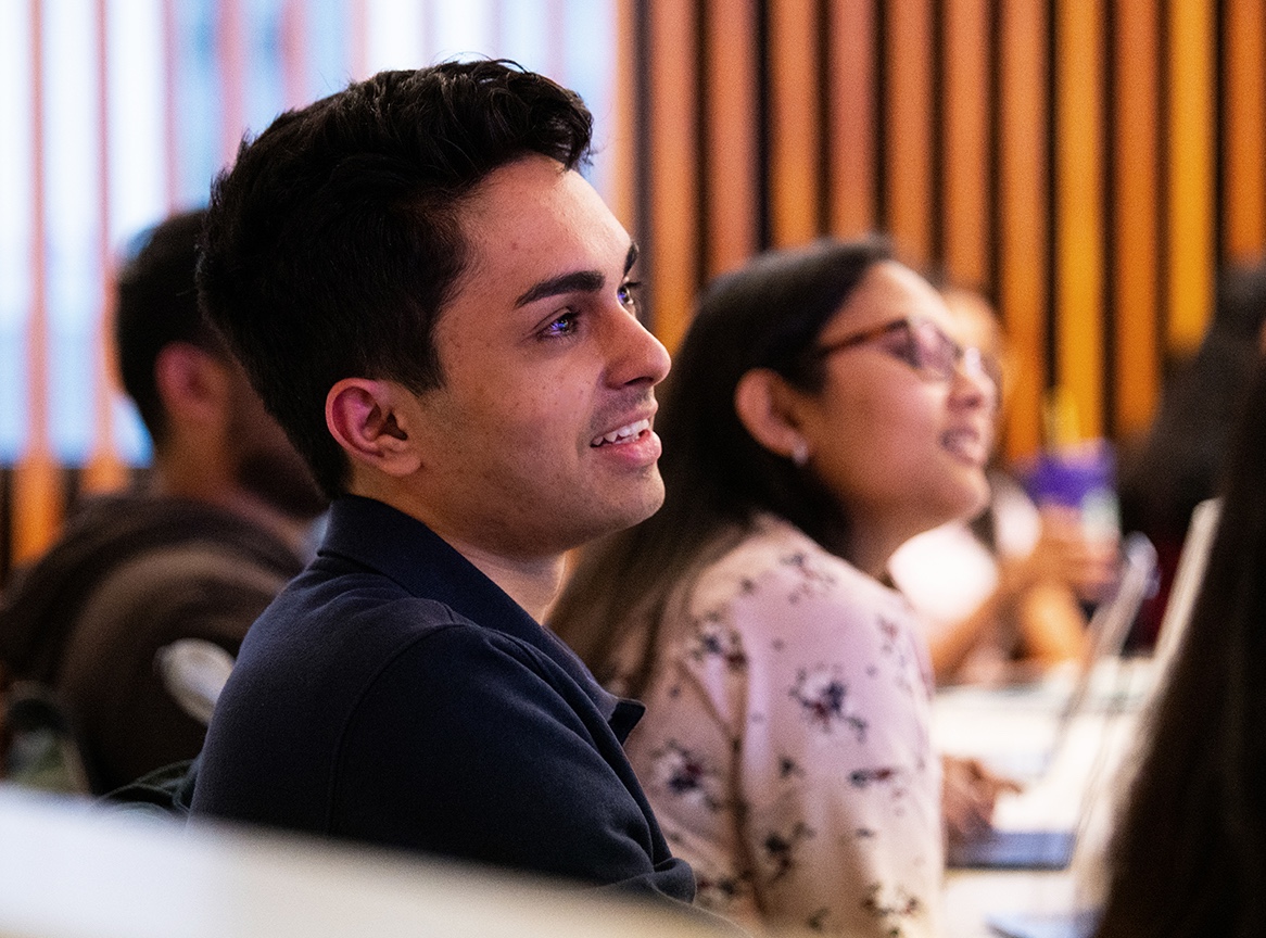 An MSIM student listens to a lecture.